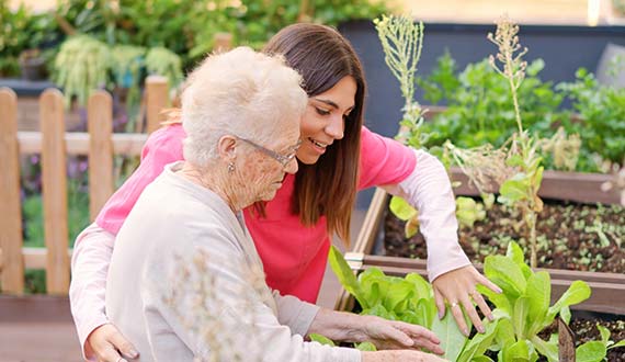 senior woman gardening with help