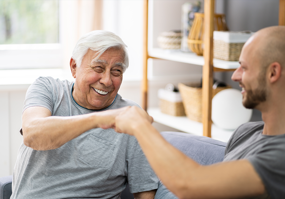 senior man fist bump with therapist